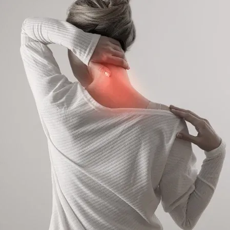 Person holding the neck with a highlighted pain area, illustrating tension, stiffness, or cervical discomfort.